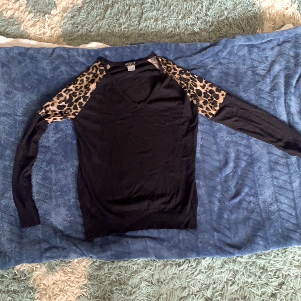 Black v neck sweater with leopard print shoulders.